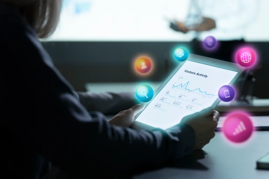 A person holding a tablet showing metrics and statistics
