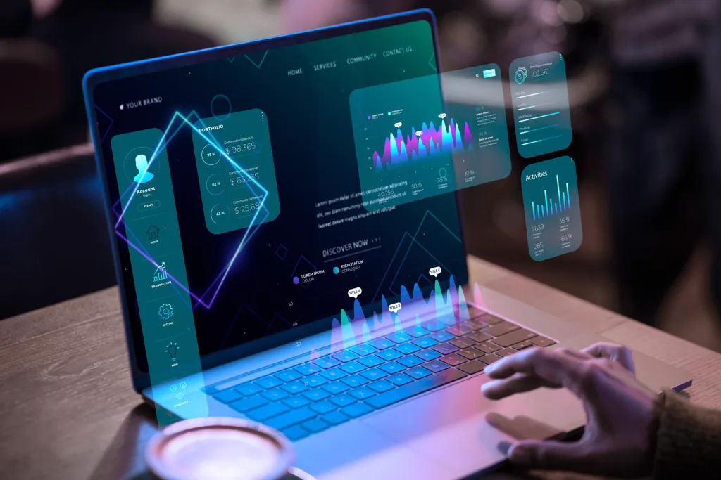 A side view of a person's hand's working on a laptop with statstics and metrics floating in front of the screen